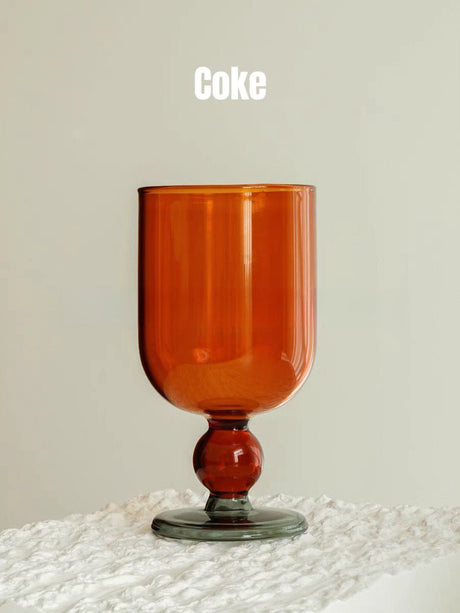 A solid amber wine glass with a matching amber gumball stem