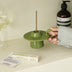 Green handmade ceramic UFO candle holder with a ring handle