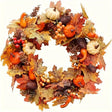 Autumn harvest wreath with pumpkins, maple leaves, berries and pine cones