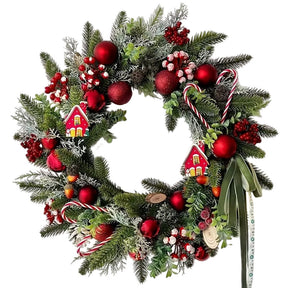 Green Christmas wreath with candy canes, red baubles and berries