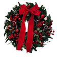 Green Christmas wreath with a large red bow, red berries and baubles