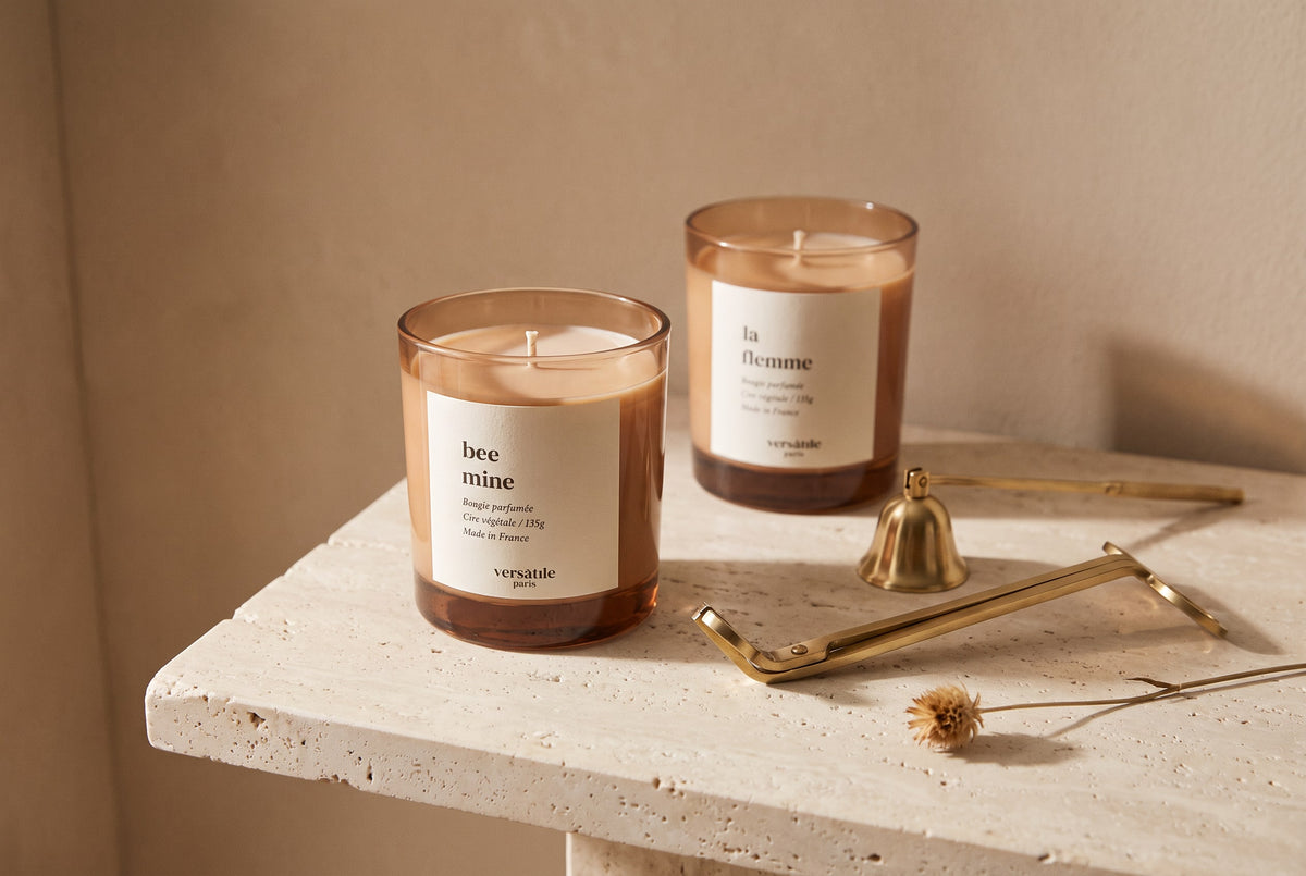 Unlit Bee Mine and La Flemme candles with a brass wick trimmer and snuffer