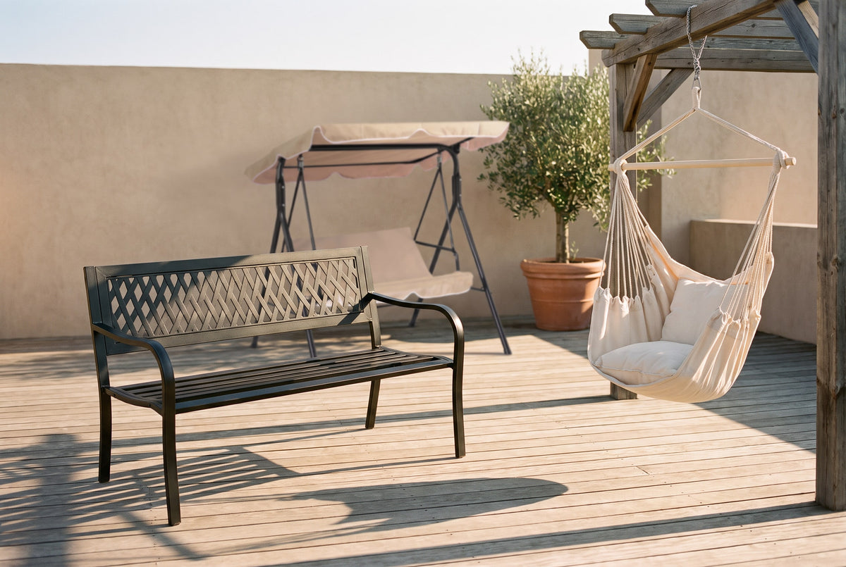 Black garden bench, hanging chair and canopy swing bed on an ordinary terrace with an olive tree