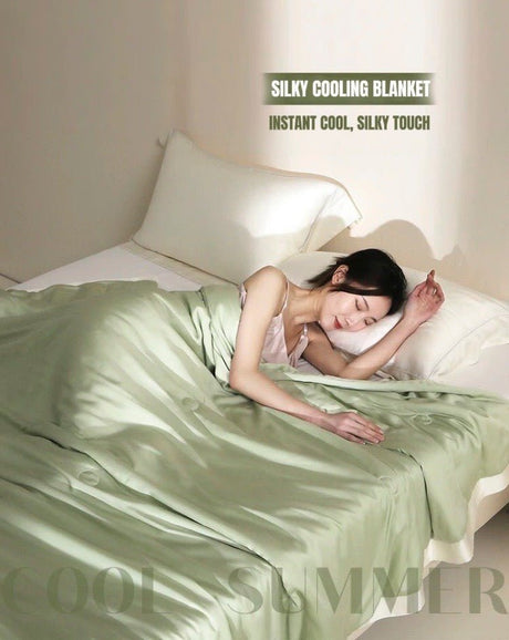Sage green bamboo and lyocell summer blanket on a bed